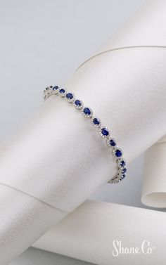 Stunning sapphires are perfect for any occasion. This shimmering bracelet features 28 stunning oval traditional blue sapphires surrounded by 336 round diamonds. Crafted from quality 14k white gold, this contemporary 7″ bracelet is secured with a safety clasp for added security. This bracelet measures approximately 1/4″ wide. Article number: 41083554 Sapphire Cubic Zirconia Diamond Bracelet For Anniversary, Sapphire Bracelets With Diamond Accents, Blue Diamond Hand-set Bracelet, Anniversary Sapphire Diamond Bracelet In Cubic Zirconia, Sapphire Color Brilliant-cut Cubic Zirconia Bracelets, Blue Diamond Wedding Bracelet, Sapphire Tennis Bracelet With Diamond Accents, Sapphire Bracelets With Prong Setting For Anniversary, Silver Sapphire Tennis Bracelet With Brilliant Cut