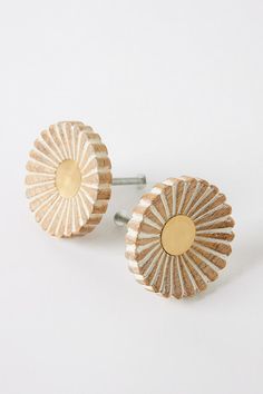 pair of gold - plated earrings on white background