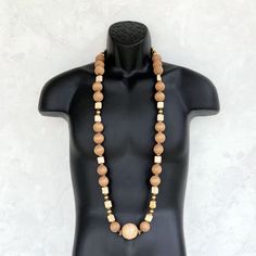 This AMAZING wood bead necklace was handmade using a mix of unique beads - large 25mm round distressed mocha brown wooden beads, an extra large 35mm round distressed beige wood focal bead, square shaped cream ceramic beads, 8mm round gold painted wood beads, small agate gemstone rondelles, and a variety of small wooden beads. This is one of the most special necklaces that I've ever made! It measures a little over 44 inches in length and is securely fastened with a sterling silver toggle clasp. P Everyday Beige Jewelry With Wooden Beads, Everyday Brown Jewelry With Large Beads, Natural Wooden Beads Necklace, Handmade Brown Necklace For Everyday Wear, Brown Handmade Necklaces For Everyday Wear, Everyday Handmade Brown Necklaces, Everyday Handmade Brown Necklace, Artisan Necklaces With Round Wooden Beads, Artisan Necklace With Wooden Beads