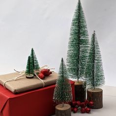 three small christmas trees sitting next to each other