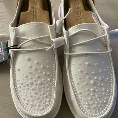 a pair of white shoes sitting on top of a table