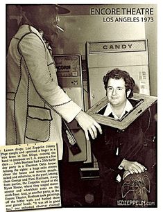 an old black and white photo of a person holding something in front of a machine