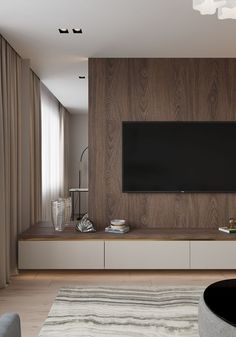 a large flat screen tv mounted to the side of a wall in a living room