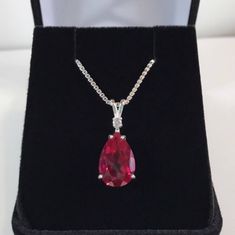 "Beautiful Ruby & White Sapphire Pendant Necklace * Pear Cut Ruby Measures 12mm x 8mm * Single Brilliant Cut White Sapphire Accent * 4cts Total Gemstone Weight * 16\" or 18\" Sterling Silver Chain Included * Solid Sterling Silver - Also available in 14kt Gold (message me for details) Hallmarked & Gift Ready! Matching Earrings & Ring Available This Gorgeous Ruby is laboratory grown. It is identical to the natural stone in every way, including chemistry, composition and hardness, with Classic Red Teardrop Pendant Jewelry, Pear-shaped Jewelry For Valentine's Day Gift, Red Pear-shaped Necklace For Gift, Classic Red Pear-shaped Jewelry, Valentine's Day Gift Pear-shaped Jewelry, Pear-shaped Gemstone Jewelry For Valentine's Day, Classic Red Teardrop Pendant Necklace, Formal Teardrop Gemstone Necklace, Pear-shaped Jewelry For Valentine's Day Formal