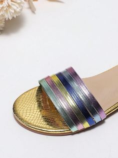 These Multicolor Metallic Band Flat Sandals are perfect for celebrating Independence Day in style and comfort. Made with a slip-resistant sole, these sandals offer both fashion and function. The metallic band adds a touch of glamour, while the comfortable design ensures all-day wear. Show off your patriotic spirit with these must-have shoes. Type : Slides Color : Multicolor Style : Funky Pattern Type : Colorblock Toe : Open Toe Upper Material : PU Leather Lining Material : PU Leather Insole Mate Rainbow Round Toe Sandals For Party, Rainbow Sandals With Round Toe For Party, Non-slip Open Toe Sandals For Party, Gold Round Toe Slides For Spring, Trendy Gold Slides For Spring, Rainbow Round Toe Sandals For Spring, Trendy Rainbow Open Toe Sandals, Spring Multicolor Slide Sandals, Multicolor Spring Slides