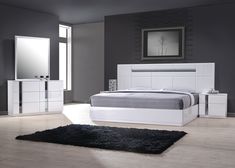 a modern bedroom with white furniture and black rugs on the floor, along with a gray wall