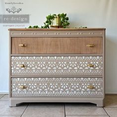 a white and brown dresser sitting on top of a tiled floor