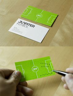 a person cutting out some business cards with scissors