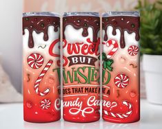 three red and white cans with candy canes on the side, one has been painted to say sweet but twisted