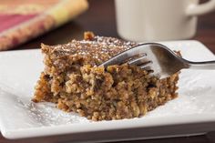 a close up of a piece of cake on a plate with a fork in it