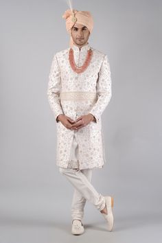 Tint pink sherwani embroidered with kasab all-over, embellished with pastel resham French knots and challa work. Paired with tint pink kurta and churidar.
Component: 3
Pattern: Embroidered
Type Of Work: Kasab pita work, French knots, crystals
Neckline: Mandarin
Sleeve Type: Full Sleeves
Fabric: Raw Silk
Color: Pink
Other Details: 
Floral motifs
Front buttons
Note: Neckpiece, kamarbandh and head accessory worn by the model is not for sale
Occasion: Groom, Wedding - Aza Fashions Pita Work, Pink Sherwani, Pink Kurta, Sherwani For Men, Luxury Sale, French Knots, Head Accessories, Churidar, Full Sleeves