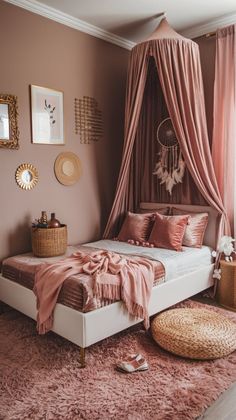 a bed with pink sheets and pillows on top of it in a bedroom next to a window