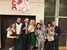 a group of people standing next to each other in front of a building wearing costumes