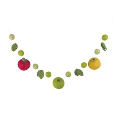 an apple, orange and lemon garland is hanging from a string on a white background