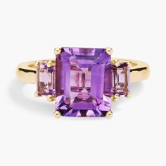 A mesmerizing amethyst sits at the centre of this gorgeous ring, flanked by pink amethysts on either side for a beautiful effect. It is crafted in 14k yellow gold, which promises a warm, timelessly luxurious gleam. Multi-stone Amethyst Ring In Yellow Gold, Yellow Gold Amethyst Gemstone With Accent Stones, Amethyst Gemstones With Accent Stones, Fine Jewelry Three Stone Amethyst Ring, Amethyst Three-stone Ring For Anniversary, Three Stone Amethyst Ring Gift, Amethyst Three Stone Ring For Gift, Three Stone Amethyst Ring As A Gift, Anniversary Three Stone Amethyst Ring