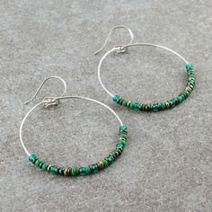 "Beaded hoop earrings. The hoops are carefully handmade of 316L stainless steel, then decorated with various Czech and Japanese glass seed beads. They are dangling from handmade, 316L stainless steel ear wires. COLORS: emerald green, forest green, olive, bronze and hematite SIZE: approx. diameter: 1.6\" / 4 cm Click here for more beaded hoop earrings: www.etsy.com/shop/LianuDesign?ref=seller-platform-mcnav%C2%A7ion_id%C2%A7ion_id&section_id=26956662 Or check out all items in the shop: www.etsy.c Nickel-free Heishi Bead Hoop Earrings, Nickel-free Hoop Earrings With Heishi Beads, Nickel-free Small Hoop Green Beaded Earrings, Nickel Free Green Small Hoop Beaded Earrings, Green Nickel-free Small Hoop Beaded Earrings, Gift Dangle Hoop Earrings With Spacer Beads, Nickel-free Small Hoop Heishi Bead Earrings, Nickel-free Metal Hoop Beaded Earrings, Green Dangle Hoop Earrings With Tiny Beads