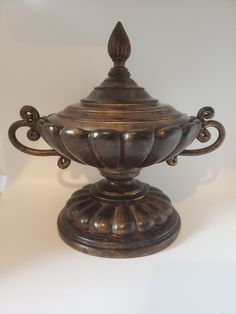 an ornately decorated metal container on a white background