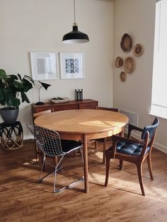 a dining room table and chairs in front of a window