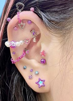 an ear with many different types of piercings on it