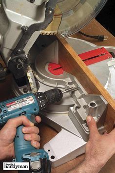 a man is using a drill to fix a hole in a piece of wood with a circular saw