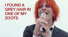 a woman with red hair is singing into a microphone and the words i found a grey hair in one of my zoots