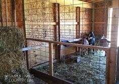 the inside of a barn with hay in it