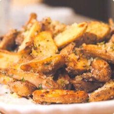 a white plate topped with fried food on top of a table