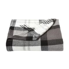 two blankets folded on top of each other with black and white plaid pattern, one in the foreground