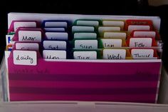 a pink and purple desk organizer with lots of notes attached to the top half of it