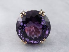 This setting is a true classic! Considered the height of fashion in the Mid Century era, the lines of this simple solitaire are clean and well balanced, providing a sophisticated look! We've set this vintage setting with a gorgeous amethyst. A bright regal purple hue, this sparkling stone glitters with intense fire from every facet. Metal: 14K Yellow Gold Gem: Amethyst 37.29 Carats Gem Measurements: 21.4 mm, Round Ring Size: 8 SKU #: HRRC19ZC Each piece has been identified and graded by a Gradua Luxury Antique Amethyst Ring For Women, Yellow Gold Amethyst Ring, Amethyst Cocktail Ring, Gold Amethyst Ring, Right Hand Ring, Crystal Goddess, Three Stone Diamond, Right Hand Rings, Amethyst Gem