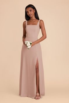 a bridesmaid in a nude colored dress holding her bouquet and posing for the camera