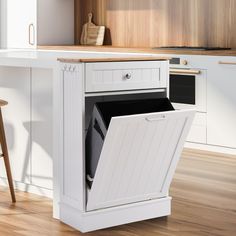 an open cabinet in the middle of a kitchen with wooden floors and white cabinets on both sides