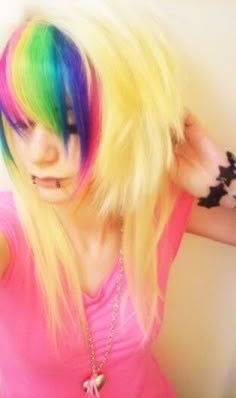 a woman with multicolored hair and piercings on her head is posing for the camera