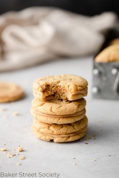 a stack of cookies sitting on top of a white counter next to a silver camera