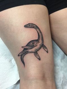 a woman's leg with a tattoo of a bird on it and the bottom part of her legs