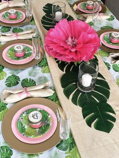 a table set with pink and green place settings