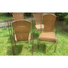 four wicker chairs sitting in the grass