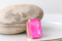 PINK FUCHSIA RING, Statement Pink Stone Ring, Hot Pink Ring, Large Unique Ring, Big Stone Cocktail Ring, Neon Ring, Dark Pink Chunky Ring Details of ring: Metal: Gold or Silver  or silver Antique plated or rose gold in finish over brass with nickel free Size of stone is 20*30 mm Gemstone: crystals Adjustable ring band width is: 30 mm The ring will be packed in a gift box. Details of the earrings: Metal: Gold or Silver or silver Antique plated rose gold in finish over brass with nickel free Size: 25*30 mm Gemstone: crystal The earrings will be packed in a gift box. FOR MY RINGS COLLECTION: https://www.etsy.com/il-en/shop/rebekajewelry?ref=hdr_shop_menu§ion_id=14282915 TO GET TO MY ETSY SHOP: https://www.etsy.com/il-en/shop/rebekajewelry THANK YOU CHOOSING MY ETSY SHOP REBEKA Pink Crystal Open Ring For Party, Pink Open Crystal Ring For Parties, Elegant Pink Ring With Large Stone, Luxury Pink Rectangular Rings, Luxury Rectangular Pink Rings, Luxury Pink Rectangular Jewelry, Pink Crystal Open Ring For Formal Occasions, Pink Rectangular Stone Jewelry For Gift, Pink Gemstone Party Ring