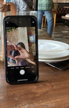 an iphone sitting on top of a wooden table