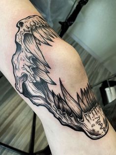 a black and white tattoo on the arm of a person with an eagle head in it