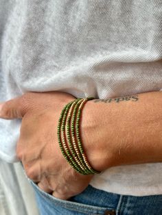 Made from speckled hunter-green Czech glass seed beads on strong elastic cording, these bracelets wrap around your wrist five times and feature strips of metallic gold Czech beads for a touch of class. These Boho beaded wrap bracelets come in a wide variety of colors, with options for metallic silver strips instead of gold. Or wear it twice around the neck as a necklace for a lively, free-spirited summer style. SIZE: Approx. 6.5 inches around Silver Sprinkles, Gold Sprinkles, Boho Wrap Bracelet, Color Vibe, Jewelry Accessories Ideas, Beaded Wrap Bracelets, Wrap Bracelets, Beaded Wraps, Bead Bracelets