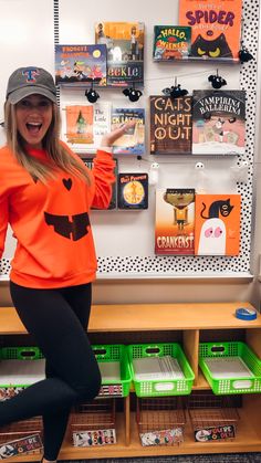 a woman in an orange shirt and black leggings is posing for the camera