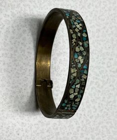 Vintage Turquoise Inlayed Bangle Bracelet Brass  Gorgeous vintage antique has no makers marks that I can see. Clasp is in great working condition. Piece has a  3"circumference and 1/2"width Needs to be cleaned will leave up to buyer. Lovely turquoise stones with tarnished brass finish perfect for boho western country farmhouse Victorian dark academia gothic style. Most items we sell are preowned and loved and sold as is. We do our best to describe each item as it is found. Please review all photos. We gladly bundle anything we list and here are a few things we offer! All items will be packed with care. MCM Retro Academia Ephemera  Country cottage Cottage core Romantic cottage Romantic farmhouse Farmhouse decor Country farmhouse Country decor Antique Turquoise Adjustable Bracelet, Antique Adjustable Turquoise Bracelet, Vintage Adjustable Hinged Cuff Bracelet, Vintage Adjustable Hinged Bracelets, Vintage Adjustable Hinged Bracelet, Antique Turquoise Jewelry With Patina, Vintage Turquoise Bracelet With Inlay, Vintage Turquoise Bracelets With Inlay, Vintage Brass Jewelry With Turquoise