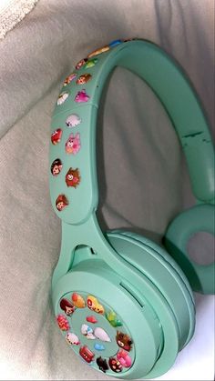 a pair of headphones sitting on top of a white sheet with cartoon stickers