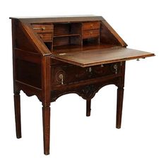 an old wooden desk with drawers on it