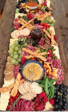 a long table covered in lots of different types of food and cheeses on top of it