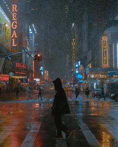 people crossing the street in the rain at night