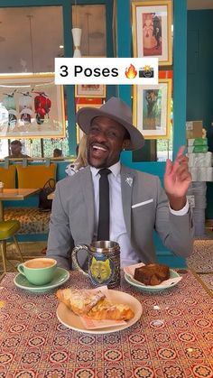 a man in a suit and tie sitting at a table with food