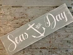 a wooden sign that says sea and day on it