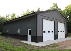 two garages are shown in the middle of a grassy area with trees behind them